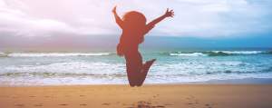 Silhouettes,Of,A,Woman,Jumping,On,The,Beach,In,Front